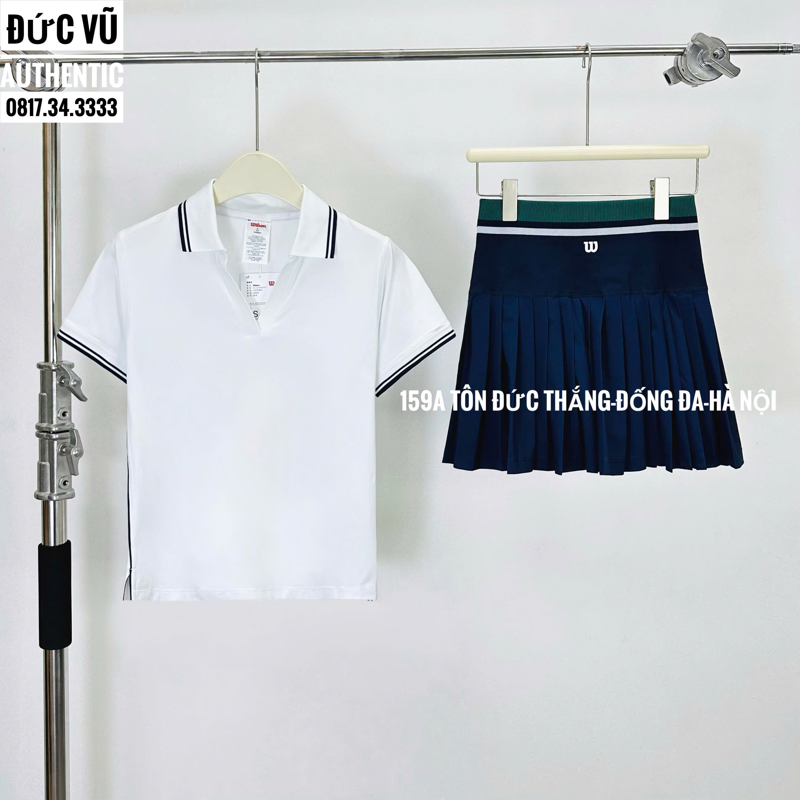 Set tennis nữ áo cổ bẻ viền đen & chân váy navy Wilson